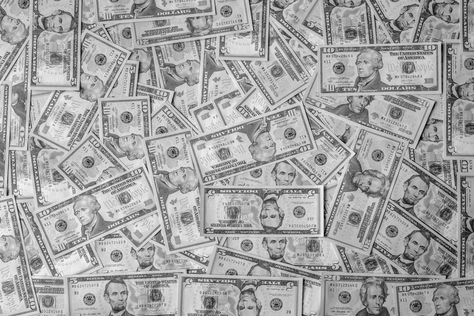 various denominations of U.S. cash paper money spread as background